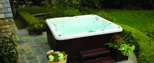 A Jacuzzi hot tub in a backyard.