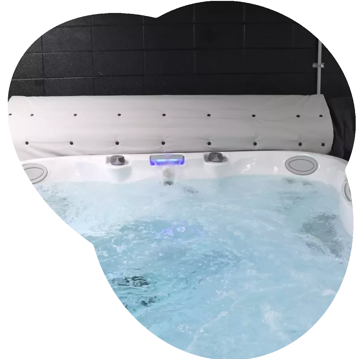 A swim spa with water in it in the All Seasons Pools & Spas show room.